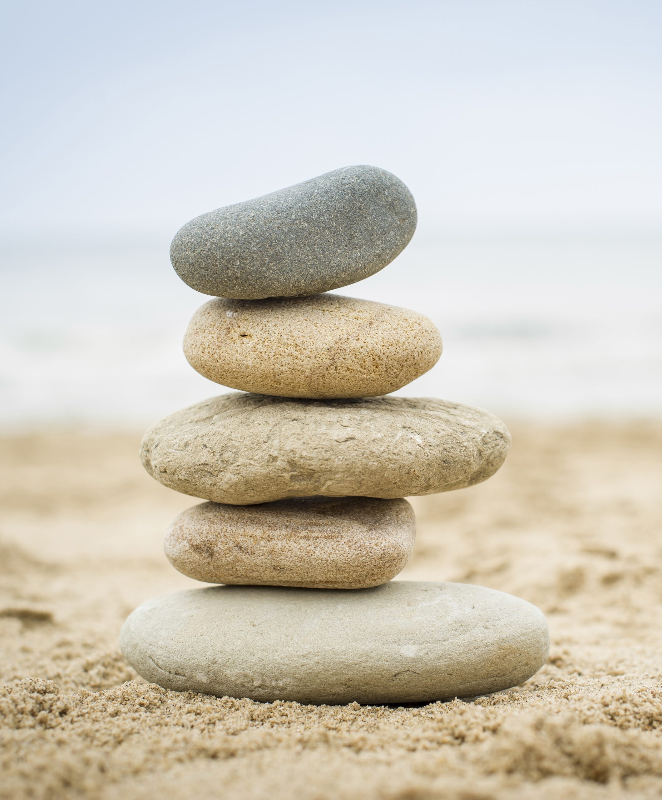 stones piled up on a sand beach